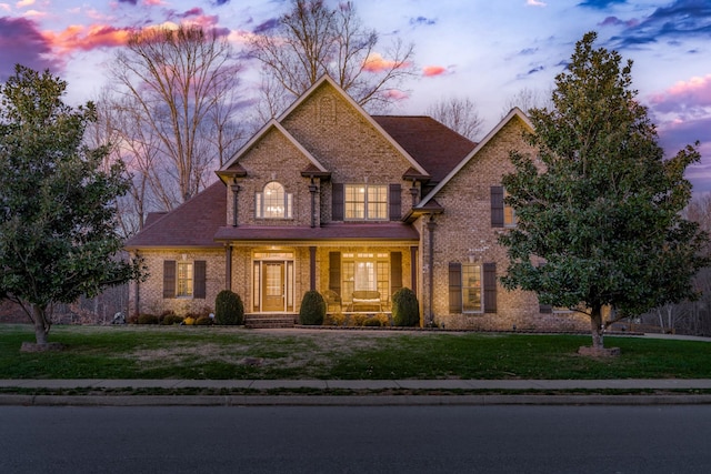 view of front of house featuring a porch and a lawn