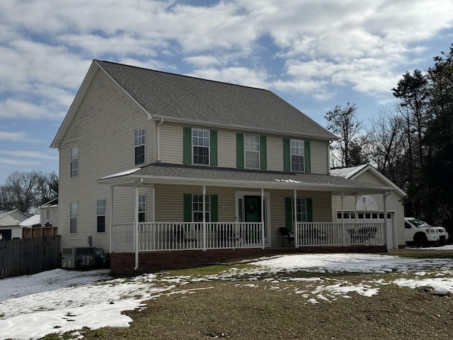 view of front of home with a porch, central AC, and a garage