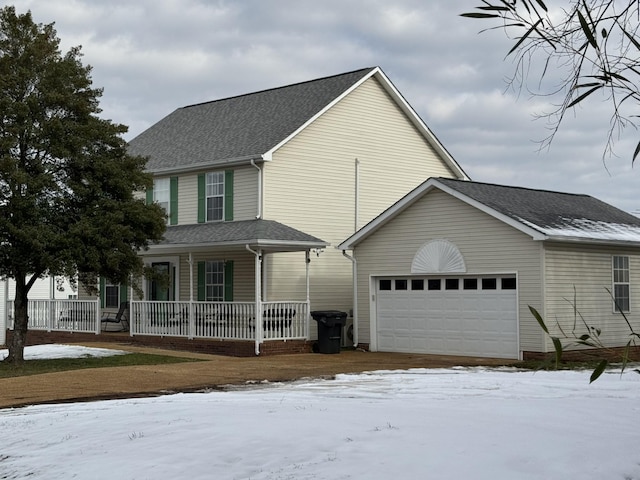 view of front of property with covered porch and a garage