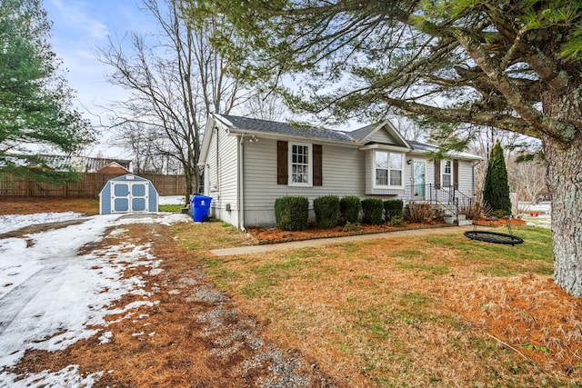 view of front of home with a front lawn and a storage shed