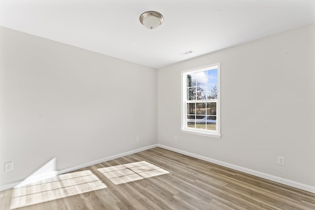 unfurnished room with wood-type flooring