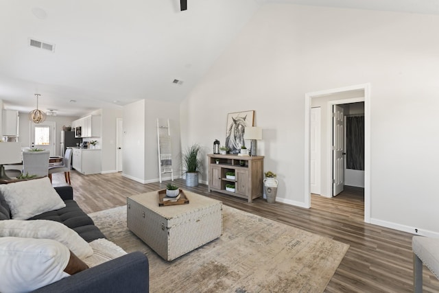 living room featuring hardwood / wood-style floors and high vaulted ceiling