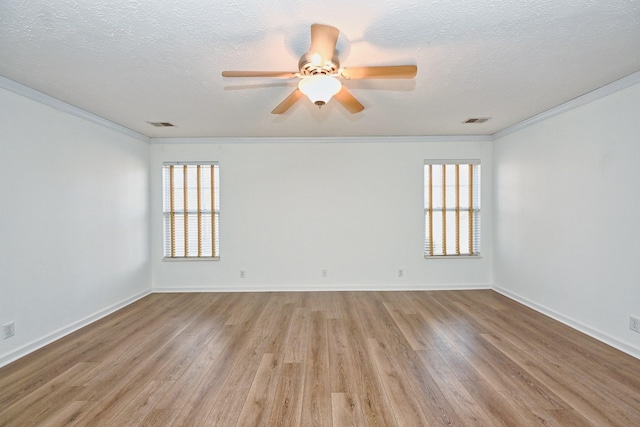 unfurnished room featuring ceiling fan, light wood-type flooring, a textured ceiling, and ornamental molding