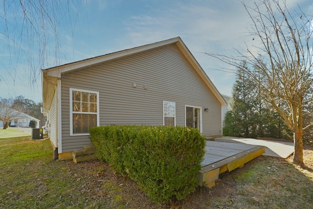 view of home's exterior with cooling unit and a wooden deck