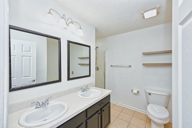 bathroom featuring vanity, a shower with door, tile patterned flooring, toilet, and a textured ceiling