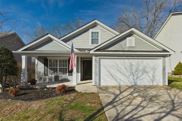 view of front of house with a porch and a garage