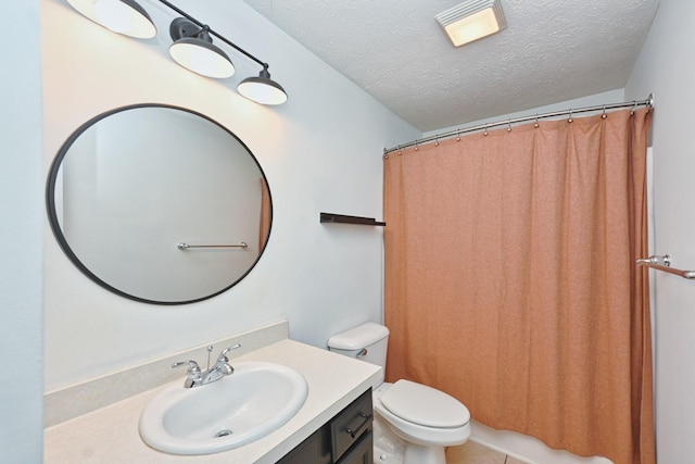 bathroom with a shower with curtain, vanity, a textured ceiling, tile patterned flooring, and toilet