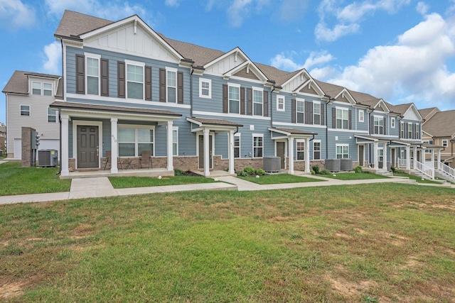 view of property with a front lawn and central air condition unit