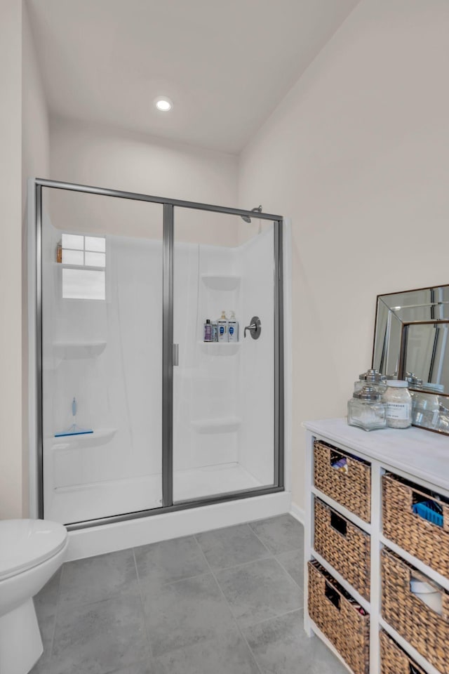 bathroom with an enclosed shower and toilet