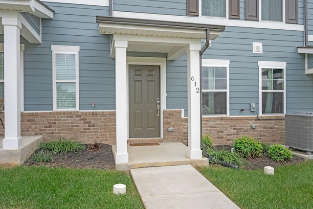 view of exterior entry with central air condition unit