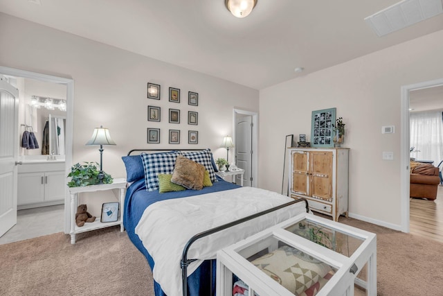 carpeted bedroom featuring ensuite bathroom