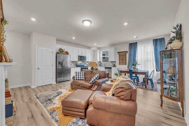 living room featuring light hardwood / wood-style flooring and sink