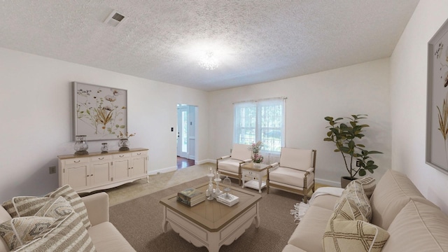 living room with dark colored carpet and a textured ceiling