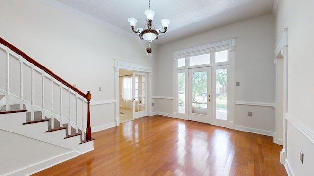 entryway featuring light wood-type flooring and an inviting chandelier