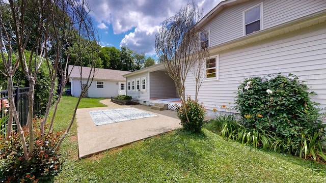 rear view of property with a yard and a patio