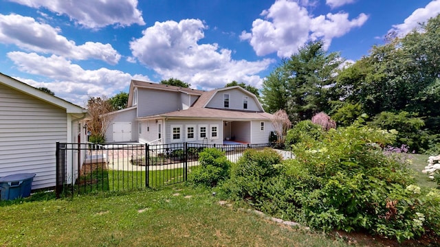 rear view of property featuring a yard