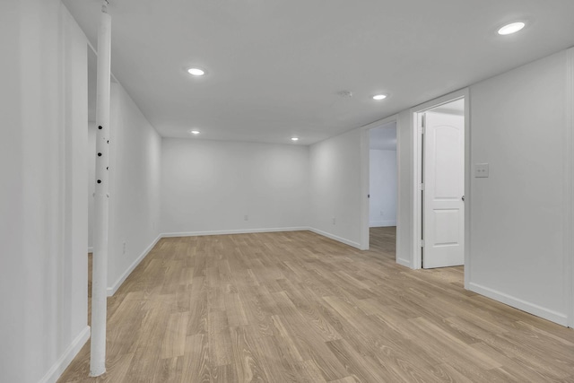 basement with light hardwood / wood-style flooring