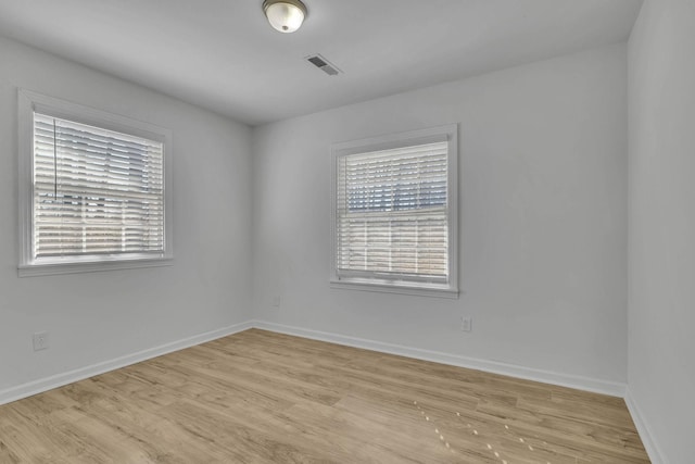 unfurnished room with light wood-type flooring