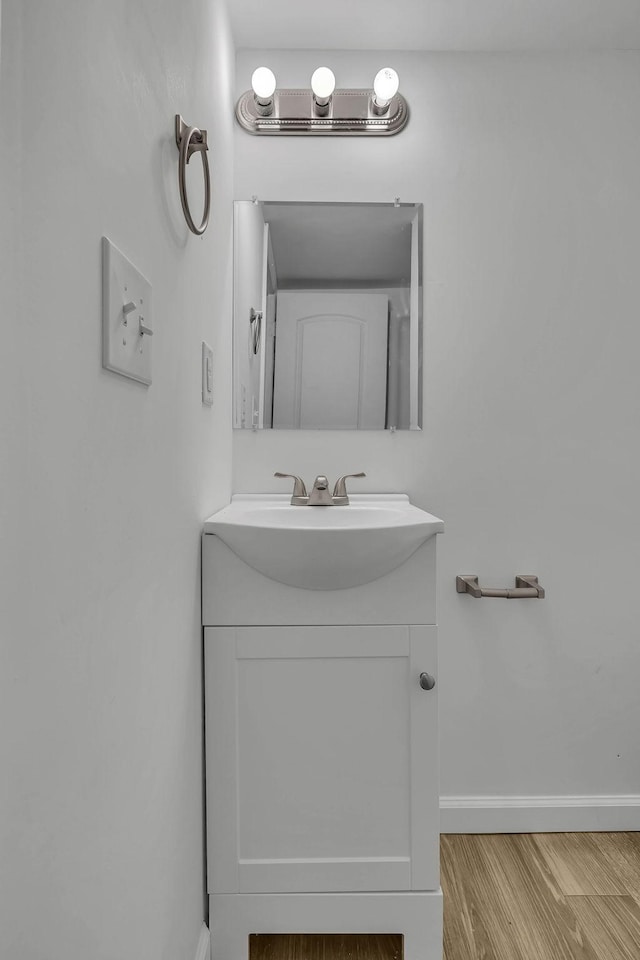 bathroom featuring hardwood / wood-style flooring and vanity