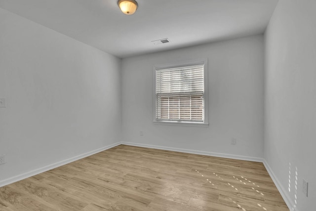 spare room featuring light hardwood / wood-style flooring