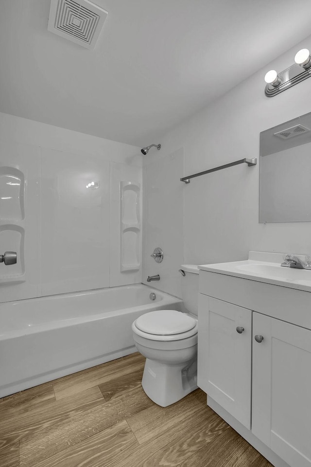 full bathroom with toilet, vanity, tub / shower combination, and hardwood / wood-style flooring