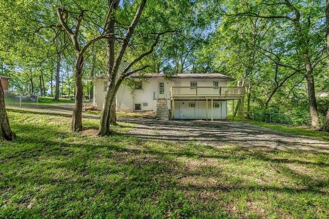 rear view of property with a yard and a wooden deck