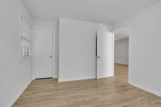 empty room with light hardwood / wood-style flooring