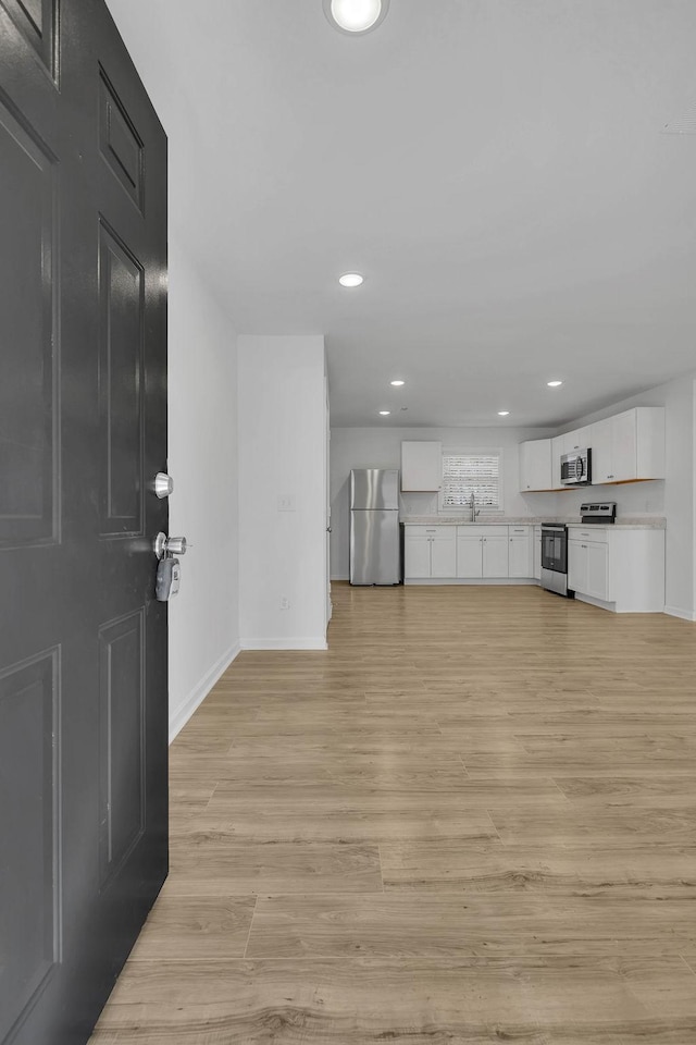 unfurnished living room featuring sink