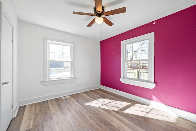 spare room featuring ceiling fan and light hardwood / wood-style floors