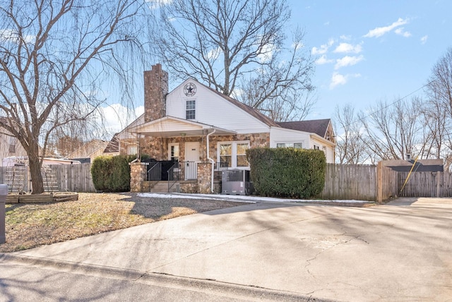 view of front of property featuring cooling unit and covered porch