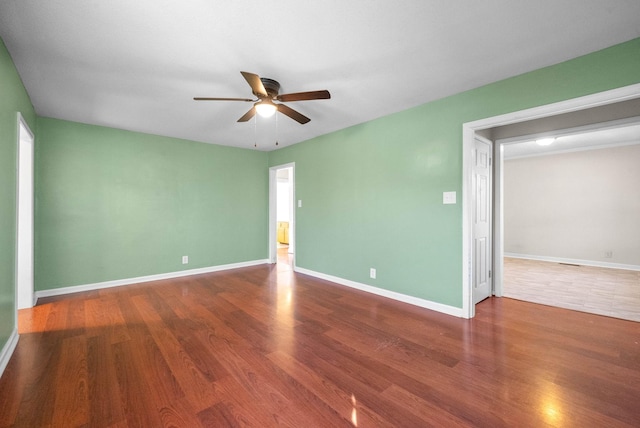 unfurnished room with ceiling fan and hardwood / wood-style flooring