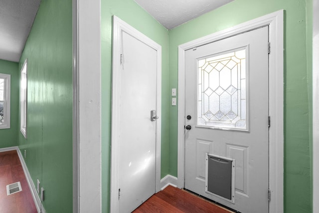 entryway featuring a textured ceiling and hardwood / wood-style flooring