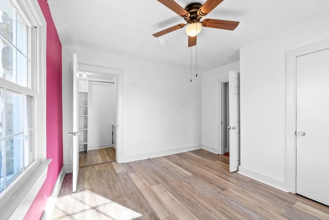 unfurnished bedroom featuring ceiling fan and light hardwood / wood-style floors