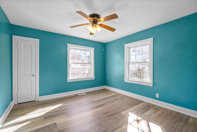 unfurnished room featuring ceiling fan and light wood-type flooring