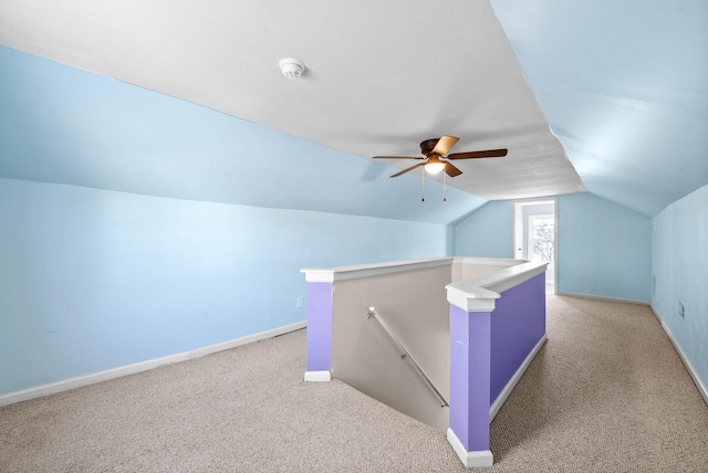 additional living space featuring ceiling fan, light carpet, and vaulted ceiling