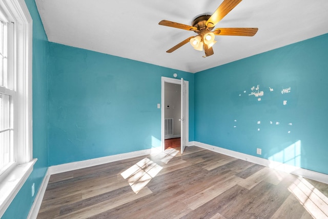 empty room featuring ceiling fan and hardwood / wood-style flooring