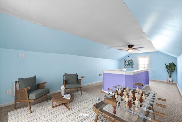 interior space featuring ceiling fan, light colored carpet, and lofted ceiling