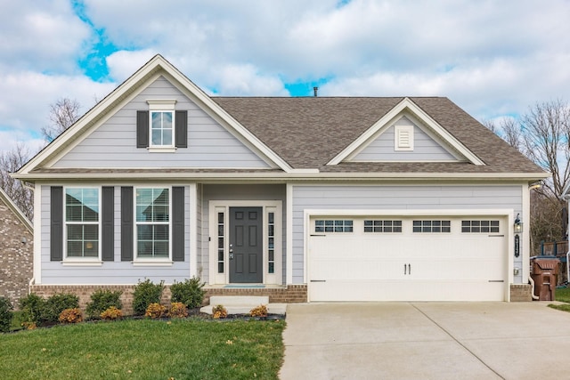 view of front of house with a front lawn and a garage