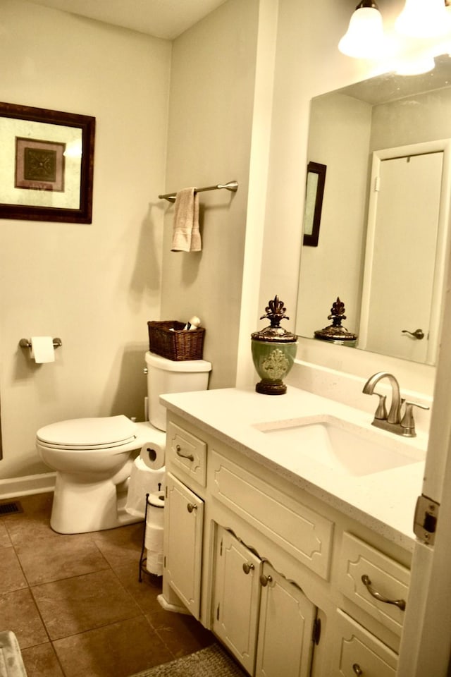 bathroom with vanity, tile patterned floors, and toilet