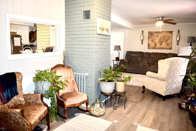 living room featuring hardwood / wood-style flooring and ceiling fan