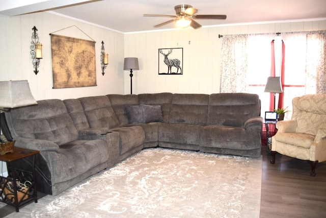 living room featuring crown molding, ceiling fan, and wood-type flooring