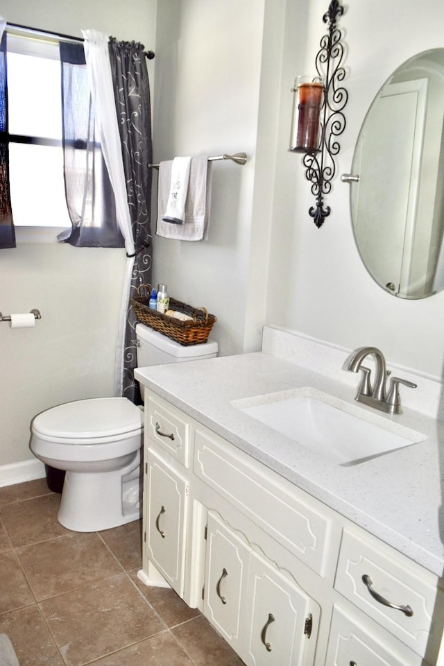 bathroom featuring tile patterned floors, vanity, and toilet