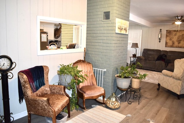 living area with ceiling fan and hardwood / wood-style floors