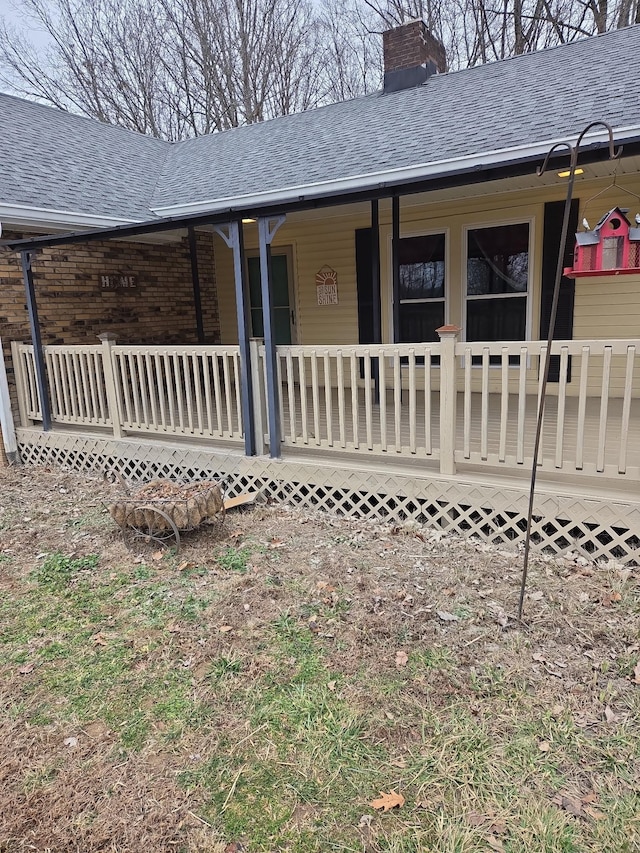 rear view of house featuring covered porch