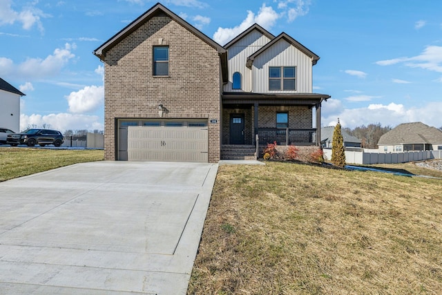 view of front of property featuring a front lawn, covered porch, and a garage