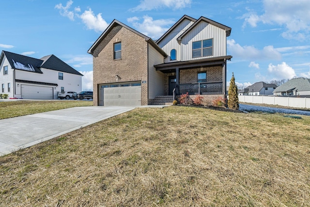 view of front of home with a porch, a garage, and a front yard