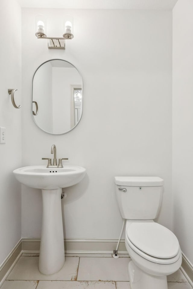 bathroom featuring tile patterned floors and toilet