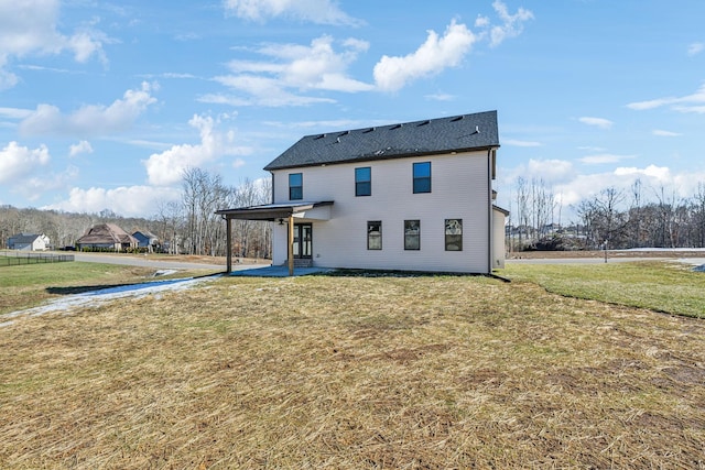 rear view of house with a lawn and a patio area