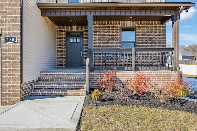 view of exterior entry featuring a porch