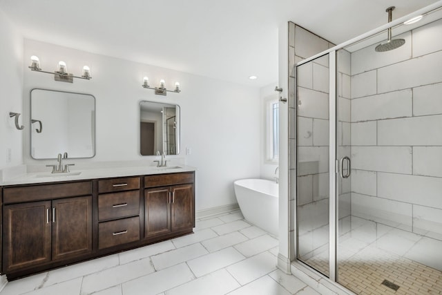 bathroom featuring shower with separate bathtub and vanity